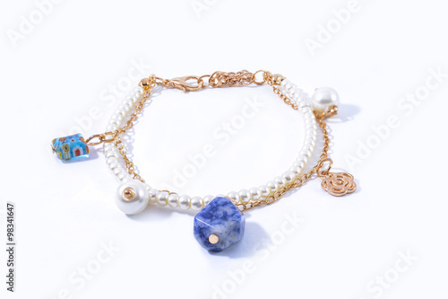 bracelet with pearls and pendants isolated on white