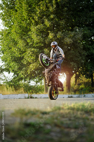 Impressive skills. Vertical soft smudged focus shot of a man riding extreme bike