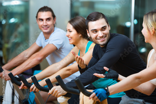 Group smiling working out of cycling in fitness club