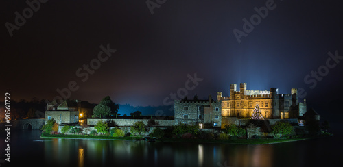 English castle with Christmas lights at night