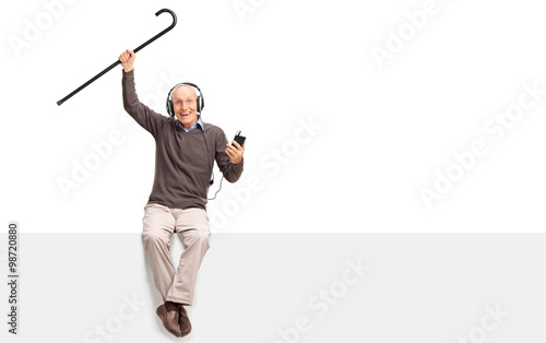 Senior man listening to music on headphones