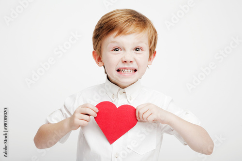 cute little boy with a red heart in the hands