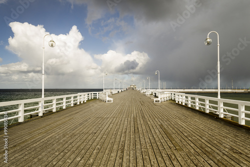 rain passing over a wooden, sea pier