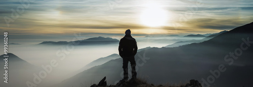 Man watching mountains clouds from a peak