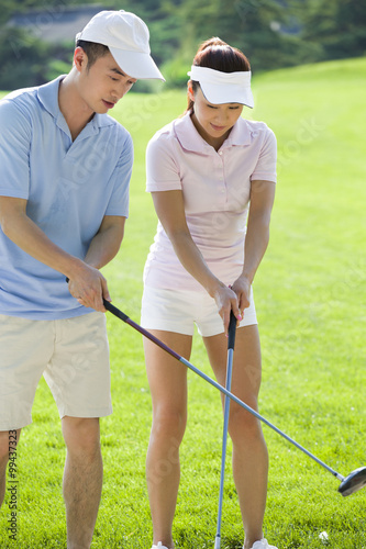 Young couple playing golf