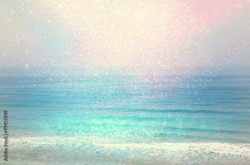 background of blurred beach and sea waves with bokeh lights, vintage filter. 