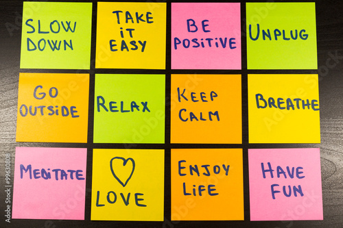 slow down, relax, take it easy, keep calm, love, enjoy life, have fun and other motivational lifestyle reminders on colorful sticky notes