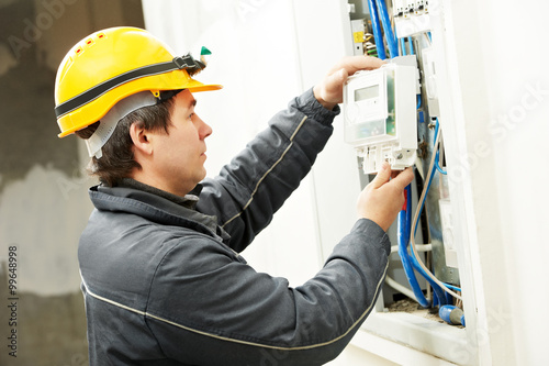 Electrician installing energy saving meter