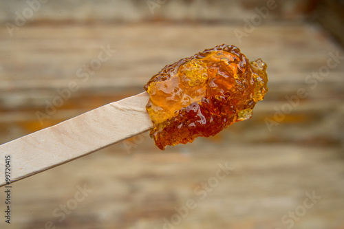 Maple taffy on a stick during sugar shack period