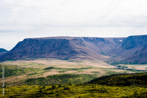 Large mountain plateau and valley under cloudy sky