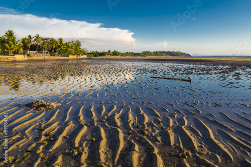 Water sky reflection on a low tide beach