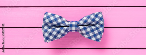 Blue bow tie on pink background