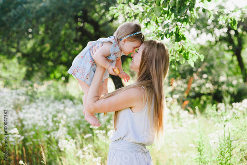 Young mother playing with her little daughter on the nature, motherhood, tenderness, childhood, tenderness, lifestyle