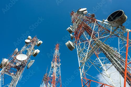 three big radio mast with blue sky