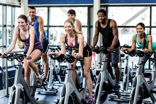 Fit people working out at spinning class