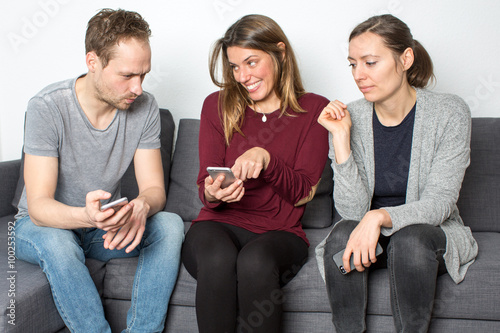 Three persons checking internet gossip