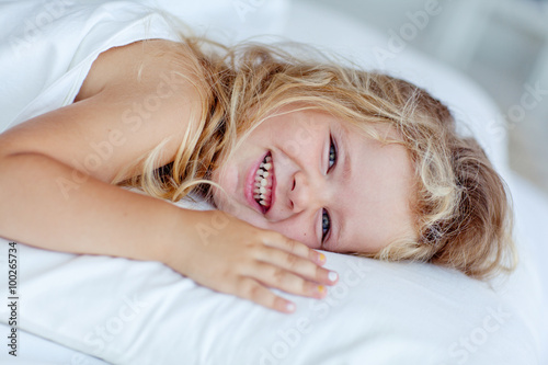 happy little girl in morning bed 