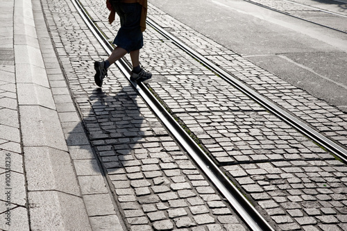 Person Walking across Tram Track in Geneva, Switzerland