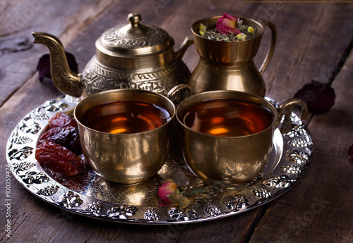 Traditional arabic tea set and dried dates.