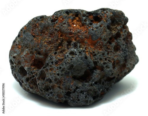 Reddish black volcanic basalt rock on white background