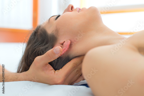 Therapist massaging the neck of woman