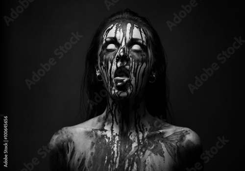 female demon.Art studio shot.Goth girl with sliced tongue