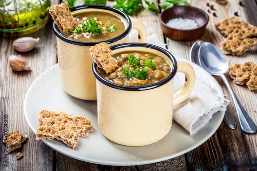 Homemade lentil soup with crispbread and parsley