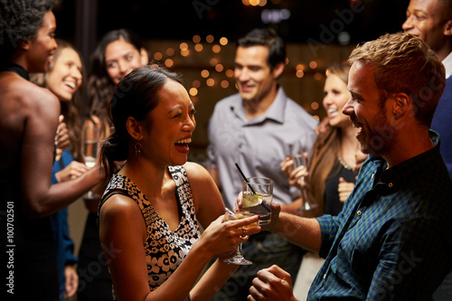 Couples Dancing And Drinking At Evening Party