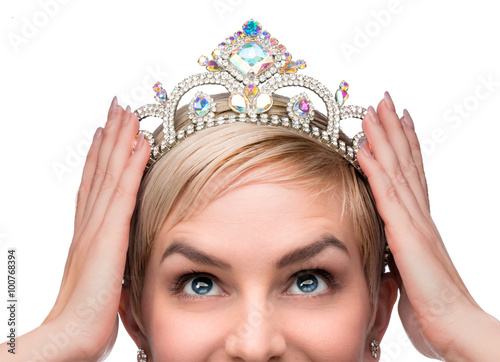 Beauty queen pageant winner placing tiara on head celebrating individuality independence courage and high self esteem