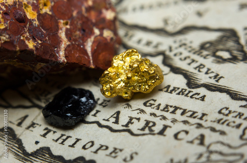 Close-up of ore deposits (gold, coal & bauxite) and an old map of Africa