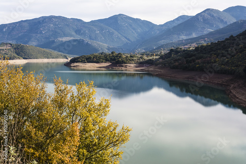 Ladonas artificial lake in Greece against a blue sky with clouds, and mountains as background