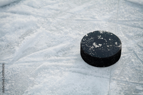 Hockey puck on ice hockey rink