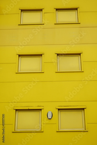 Detail of facade with windows painted in yellow
