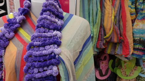 Purple scarf hanging on a mannequin.