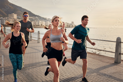 Group of young people doing running workout