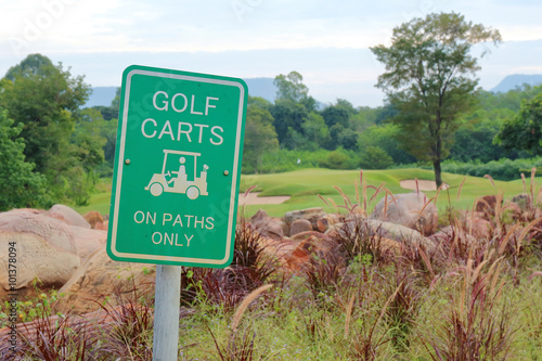 The warning sign of golf carts on paths only, for protecting gre