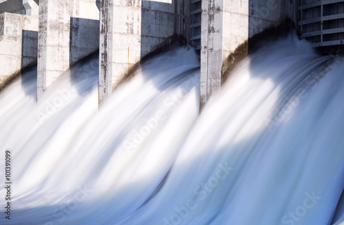 Water rushing out of opened gates of a hydro electric power dam in long exposure