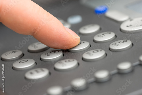 closeup of businessman Dialing Number On Telephone Keypad