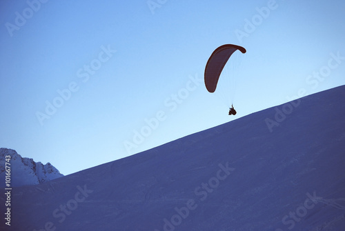 paragliding in winter in mouintans, sunset with paragling