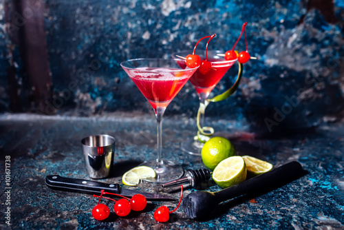 cosmopolitan cherry martini cocktail, served cold with lime and ice
