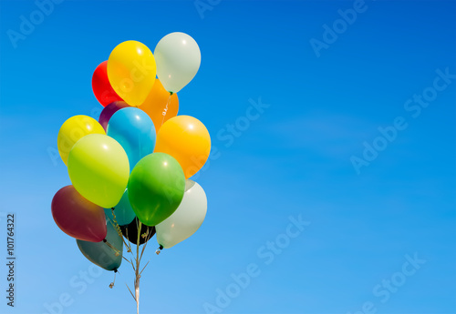 Colorful bunch of helium balloons isolated on background