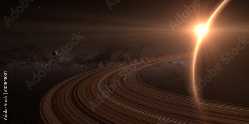 planet saturn with rings at sunrise on the space background 