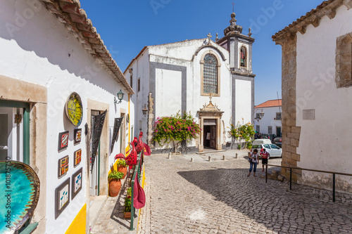 Obidos, Portugal. Sao Pedro church and a souvenir shop. Obidos is a medieval town inside walls, and very popular among tourists.