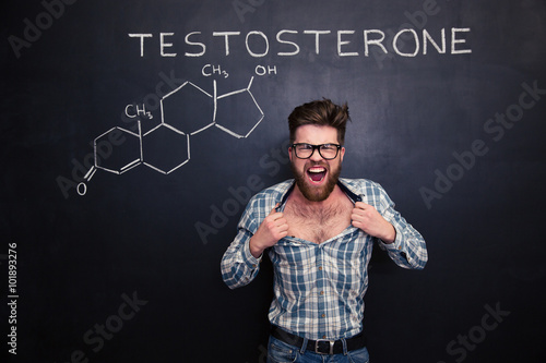 Aggressive man in glasses screaming and tearing off his shirt