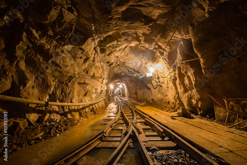 Gold mine underground ore tunnel with rails