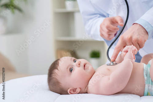 Professional pediatrician examining infant 