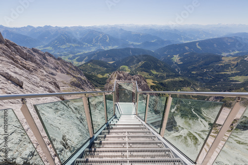 Steps to a hanging lookout of alpine landscape seen from Dachste