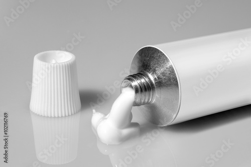 tube of white color on a gray background