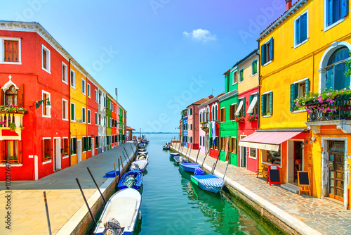 Venice landmark, Burano island canal, colorful houses and boats,