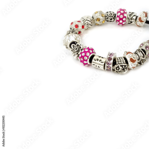 Modern fashion jewellery with charms and pendants, bracelet on white background
